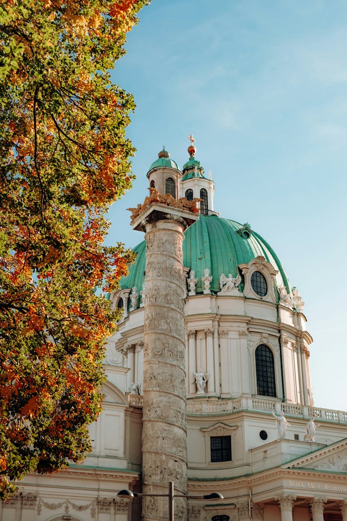 Beautiful autumn view of Karlskirche with vibrant foliage in Vienna, Austria.